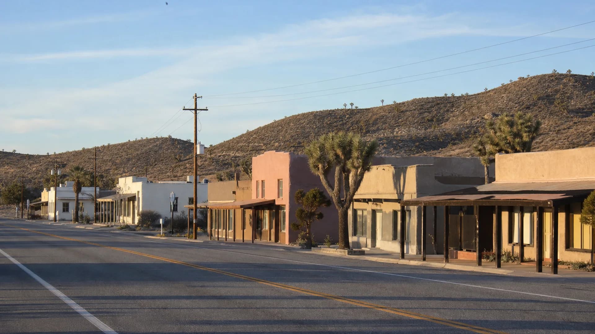 Highway 62 downtown Joshua Tree town, one-story storefronts and Joshua trees, not the park